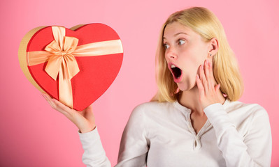 Excited about valentines day gift. Every girl would love on valentines day. Romantic surprise gift for her. Heart melting valentines day gifts that every girl wants. Woman hold heart shaped gift box