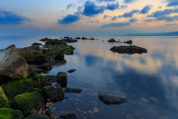 Stones covered with silt on the coast of the boulevard in Baku