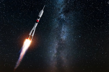 Rocket against the starry sky. The concept of space exploration, satellite launch, flight to the...