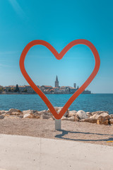 red heart on the beach of porec, croatia