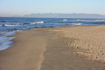 desolate blue sea. sandy beach and slightly rough sea. a clear winter's day.