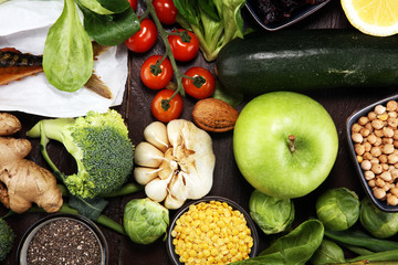 Healthy food clean eating selection. fruit, vegetable, seeds, superfood, cereals, leaf vegetable on rustic background