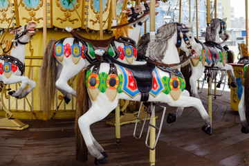 Carousel with rocking horses in the park. Children's carousel is closed for the winter season.
