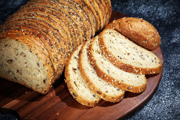 freshly baked bread on wooden board. cutted bread