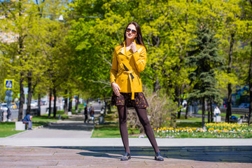 Young beautiful woman in golden jacket