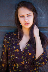 Fototapeta premium Beautiful brunette woman in sexy brown dress