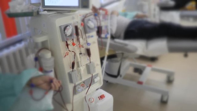 Hemodialysis. Machine artificial kidney. The hand of the patient is connected to the blood purification apparatus. Blood is pumped through transparent tubes by pumps.