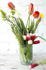 Spring still life of fresh vegetables and flowers.