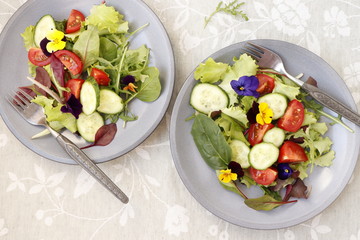 Vegetarian salad with fresh vegetables and flowers.