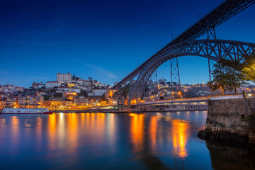 Fototapeta na wymiar Porto, Portugal. Cityscape image of Porto, Portugal with reflection of the city in the Douro River and the Luis I Bridge during twilight blue hour.