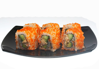 japanese  rolls on black plate.