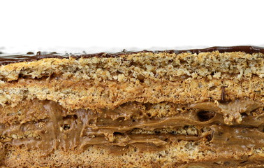 Cake with chocolate and caramel cream layers. Isolated on white background. Section of multilayer...
