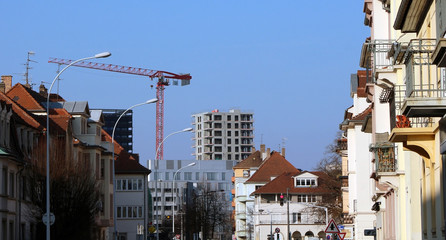 new apartment block construction behind older neighbourhood