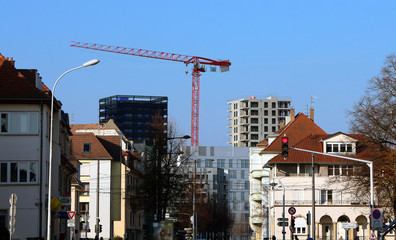 new apartment block construction behind older neighbourhood
