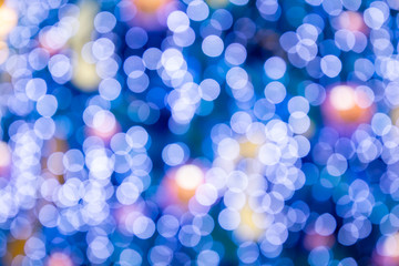 Blurred bokeh light background, Christmas and New Year holidays background. Colorful beautiful blurred bokeh background with copy space. Holiday texture. Glitter multicolored light spots.
