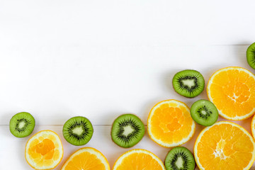 Fresh kiwi and orange sliced. Background for the profile, design, printing with fruit. The basis for the banner with orange and kiwi. Fresh and natkralnye vitamins. Healthy food. Flat lay, top view.