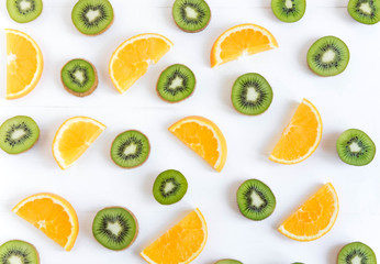 Pattern with oranges and kiwi slices on a white wooden background. The basis for the booklet, the background for the banner. Basis for design with tropical fruits