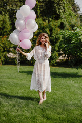 Woman holding balloon on nature background.