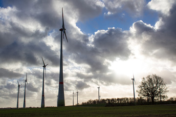 wind farm with cloudy sky in the background