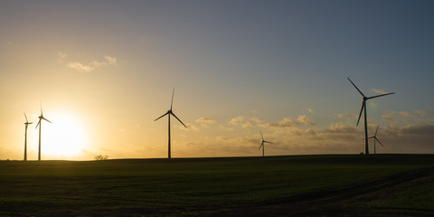 Scenic sunset behind a wind farm, panorama