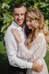 Naklejka premium Happy young couple in love having a good time and embracing in the park.