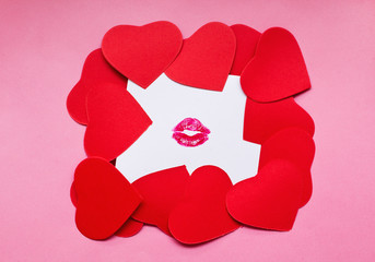 Heart shape cards on kissed white paper. Valentine day concept.