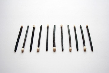 Black wooden safety matches barcode abstract composition isolated on white background