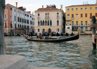Fototapeta na wymiar Historical buildings and romantic gondola in Venice. Italy