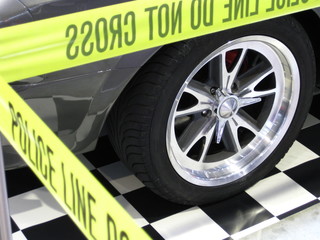 new wheel with shining silver rim locked by police do not cross