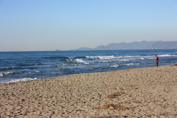 desolate blue sea. sandy beach and slightly rough sea. a clear winter's day.
