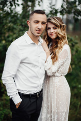 Fototapeta premium Happy young couple in love having a good time and embracing in the park.