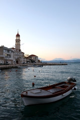 Small fishing boat in the port of Sutivan, town on island Brac, Croatia during dusk. Selective focus.