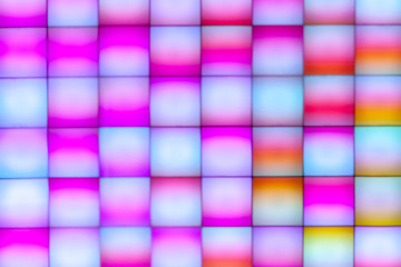 top view abstract colorful disco led panel. modern light equipment for design or ornament.pink and yellow color gradient squares.futuristic light equipment.party atmosphere. romance and funny concept