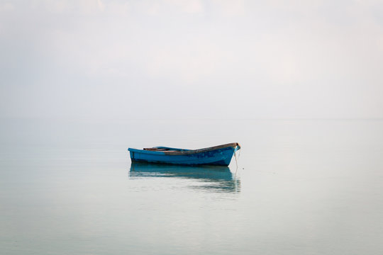 Blue boat on the ocean near an island in Cambodia