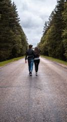 Couple walking on a forest road