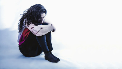 Body language of the woman as a symbol of loneliness and depression. (Negative emotion, gestures,...
