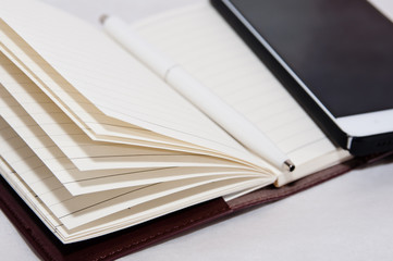 Notebook on the table. The first item to write the right ideas.