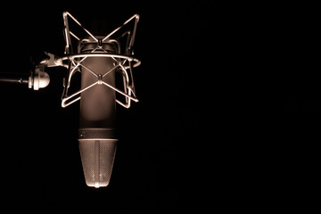 microphone detail in music and sound recording studio, black background, closeup