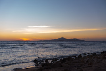 Orange sunset over a tropical island