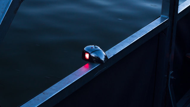 Front bow bi-color boat light showing the red port side, as required by regulations