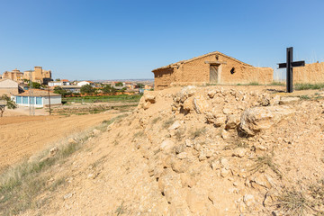 Fototapeta na wymiar abandoned rustic house made of clay and a cross - suburb of Cetina town, province of Zaragoza, Aragon, Spain