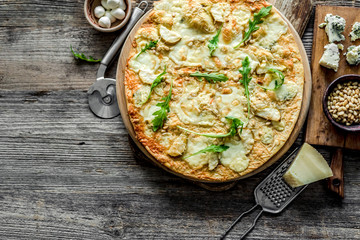 Pizza four cheeses on the table