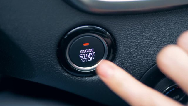 A person pressing start button three times, close up.