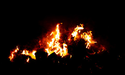 Fototapeta na wymiar Flame of fire on a black background