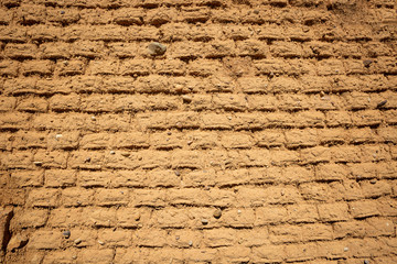 background of a wall made of old mud bricks 