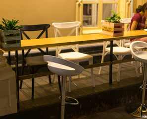 tables and chairs in the outdoor dining area at night