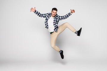 Full length, legs, body, size profile side view portrait of handsome attractive man jupm isolated on white background