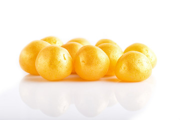 Heap of yellow hard sugar candies.