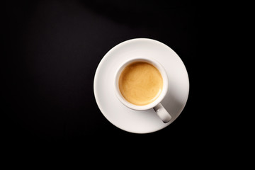 Obraz na płótnie Canvas Cup of coffee on black background. Top view. Copy space.