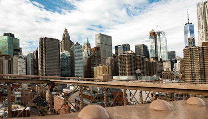 Naklejka premium Manhattan skyline seen from the beautiful Brooklyn bridge. Cloudy day in New York City, USA.